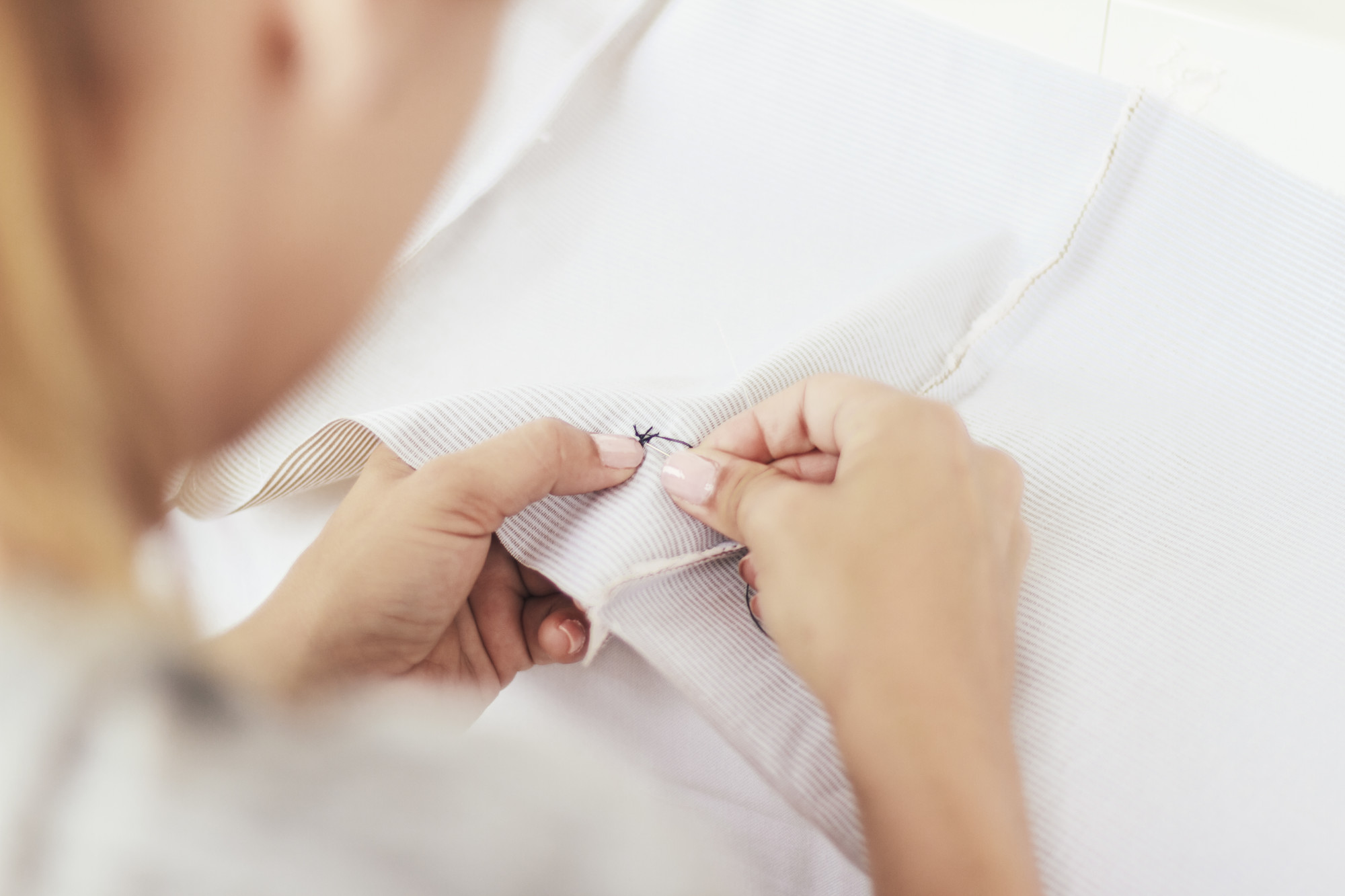 Instructor demonstrating satin stitch on linen