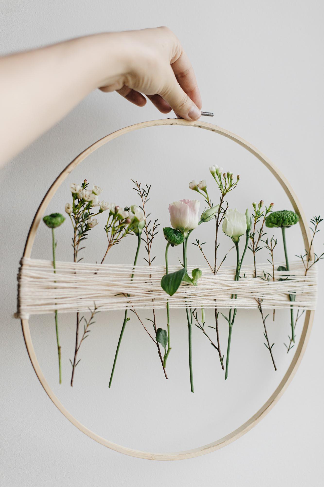 Finished botanical embroidery on hoop with textured stitches