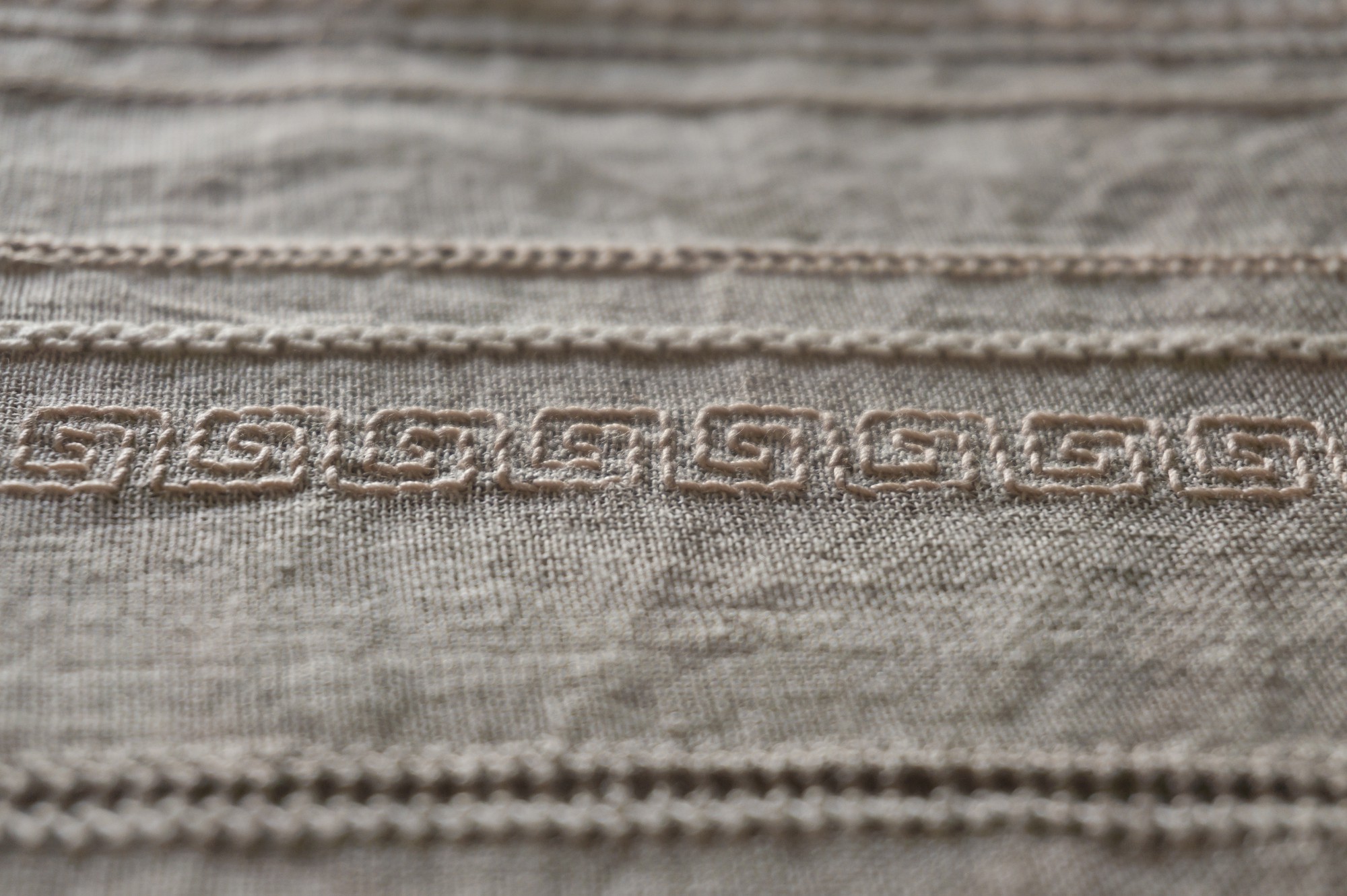 Close-up of satin and split stitches on linen